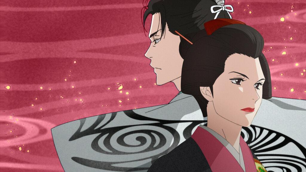 A fierce woman in traditional Japanese garb stands in front of a man in a fancy kimono with his back to her.